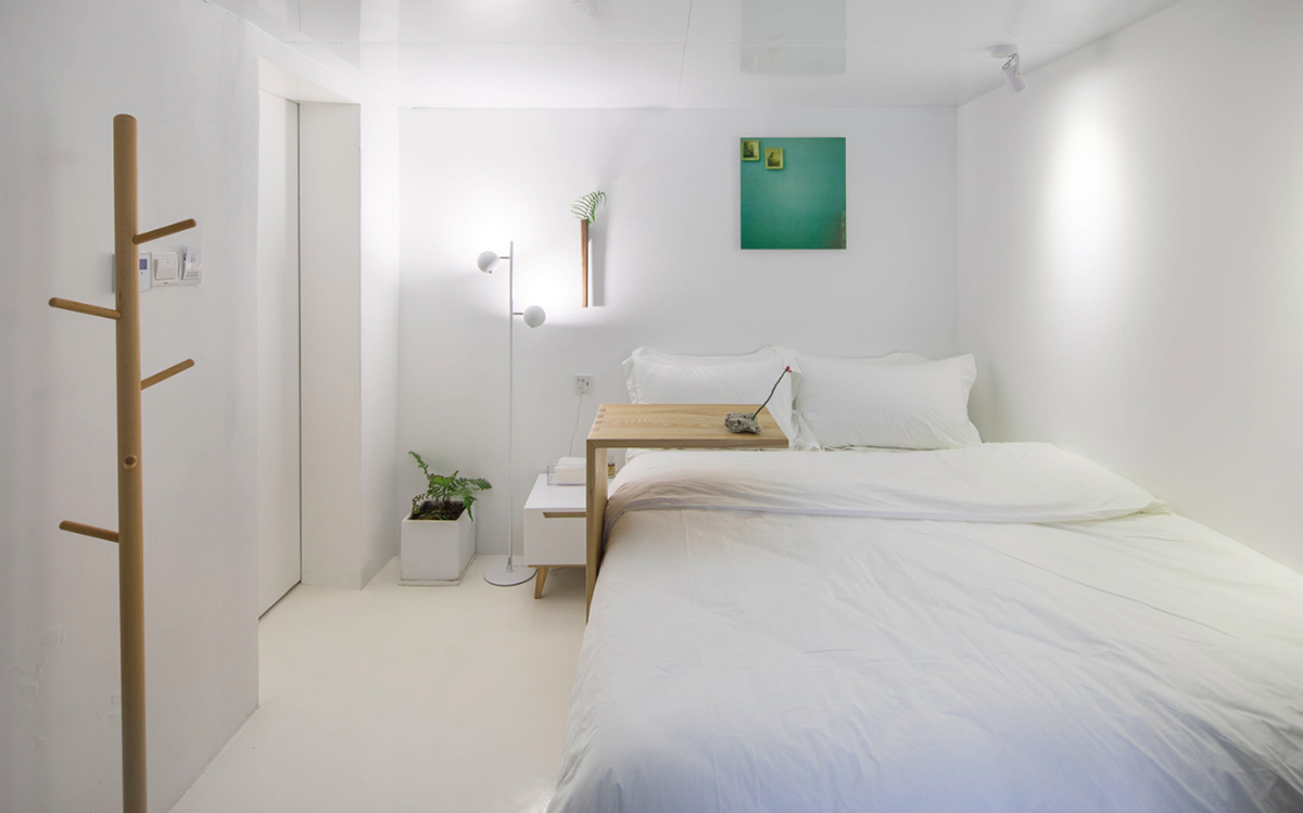 Aether Architects converted old village house into a local hostel by wrapping with structural lattice