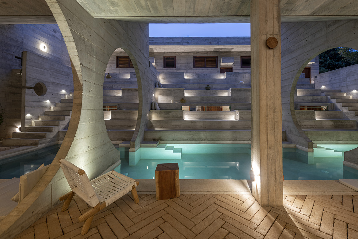 Casa TO by Ludwig Godefroy features an island of stairs and vaulted volumes to create discreet oasis