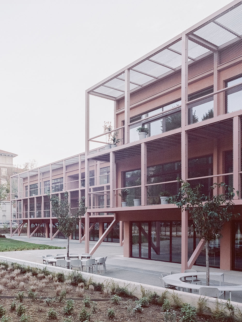 BDR bureau completes community school with pinkish steel framework in Turin
