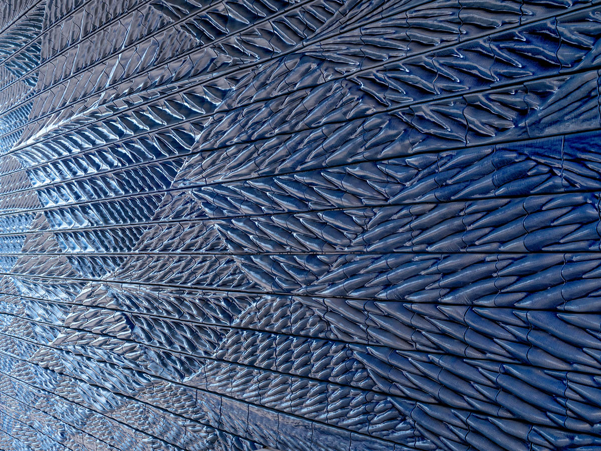 Studio RAP clads two gates of PoortMeesters residential building block in 3D blue porcelain