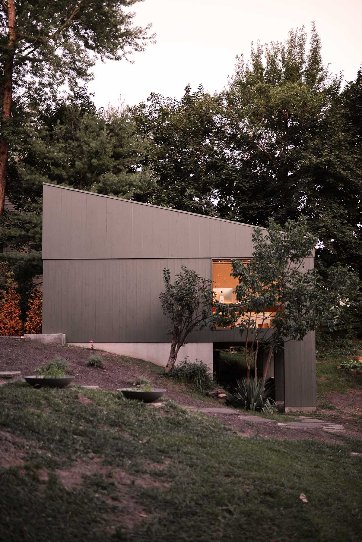 An artist's studio floats and illuminates in the landscape in Germantown