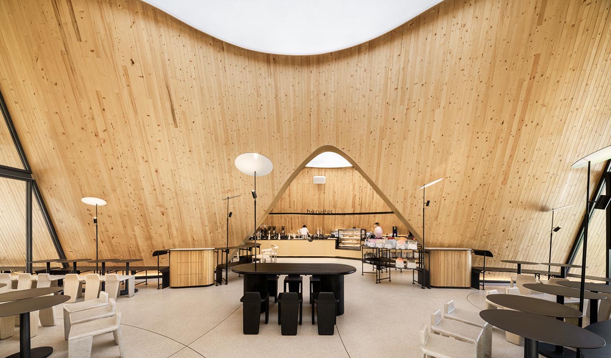 A baobab tree informs a cafe featuring three gable and fluid forms in Thailand by IDIN Architects