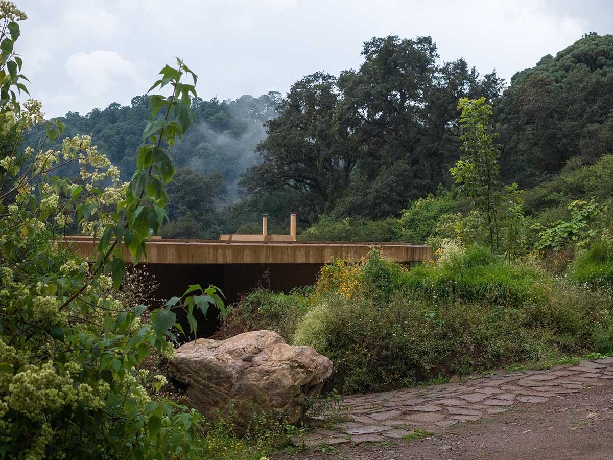 Fernanda Canales creates a circular home framing a mountain and a volcano in Mexico