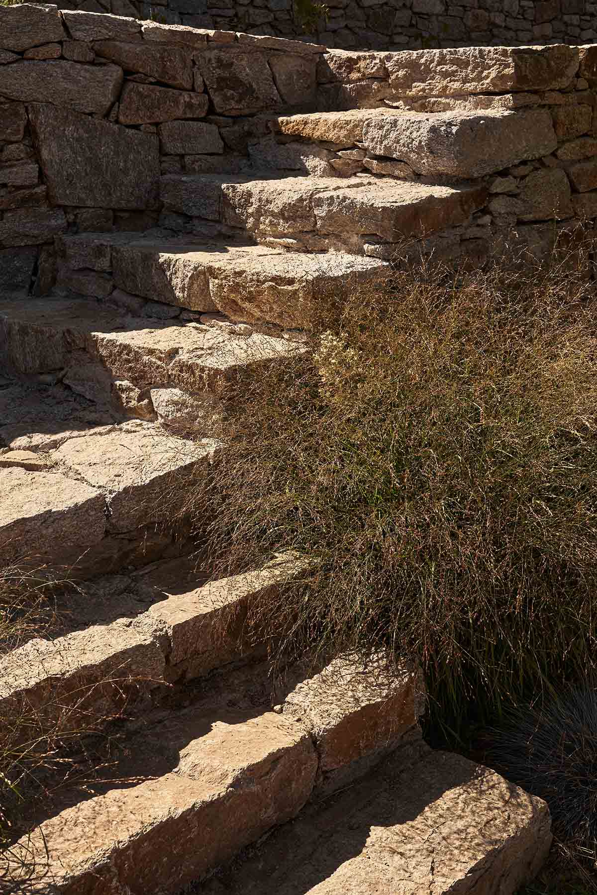 Terraced stonewalls sprawl down to offer an exploratory route in an old vineyard in Samos