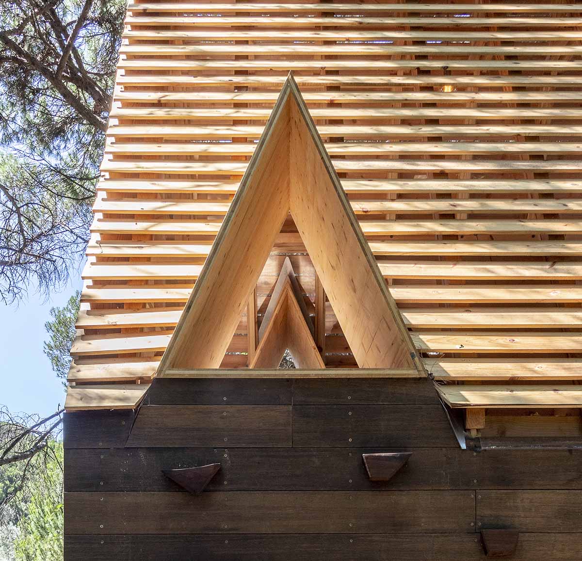 Wooden cabin by Madeiguincho is nestled among trees like an 