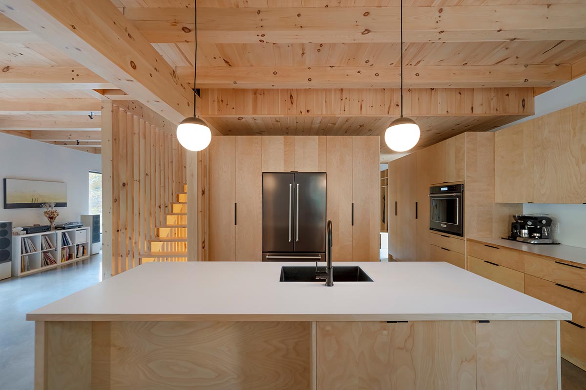 Country home is a wooden shelter that brings tranquility in the heart of the forest in Canada