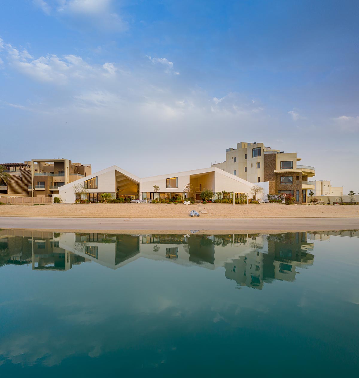 Family house is covered by folded roof to create a tent-like structure on Kuwait's seaside 