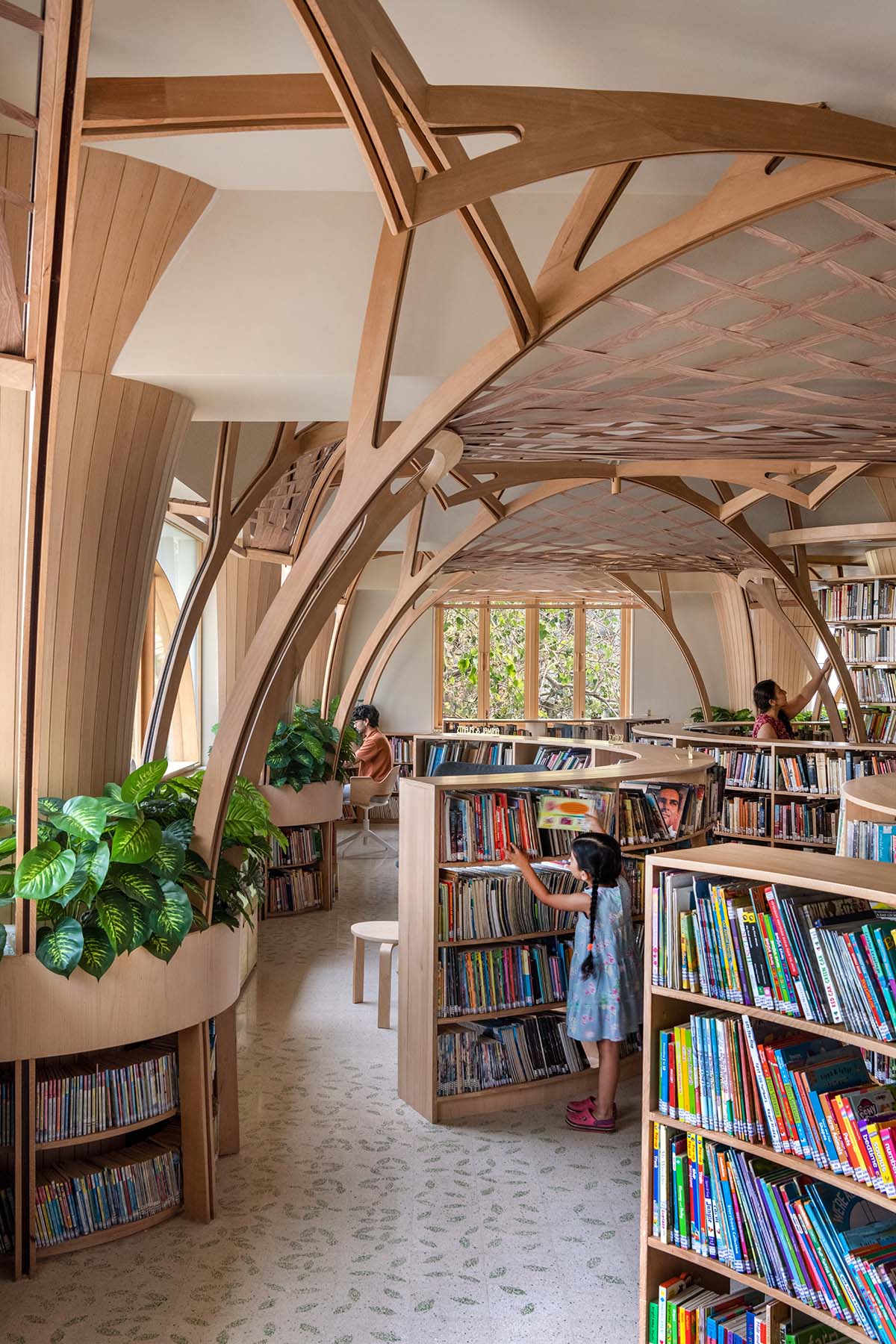 studio Hinge embeds a library under the wooden tree-like canopies in Mumbai