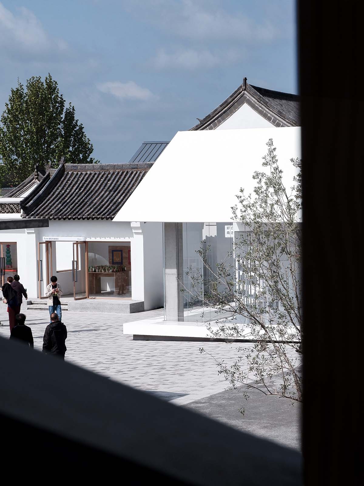 A shop is attached to Beijing historic Hutong houses with white-colored skin