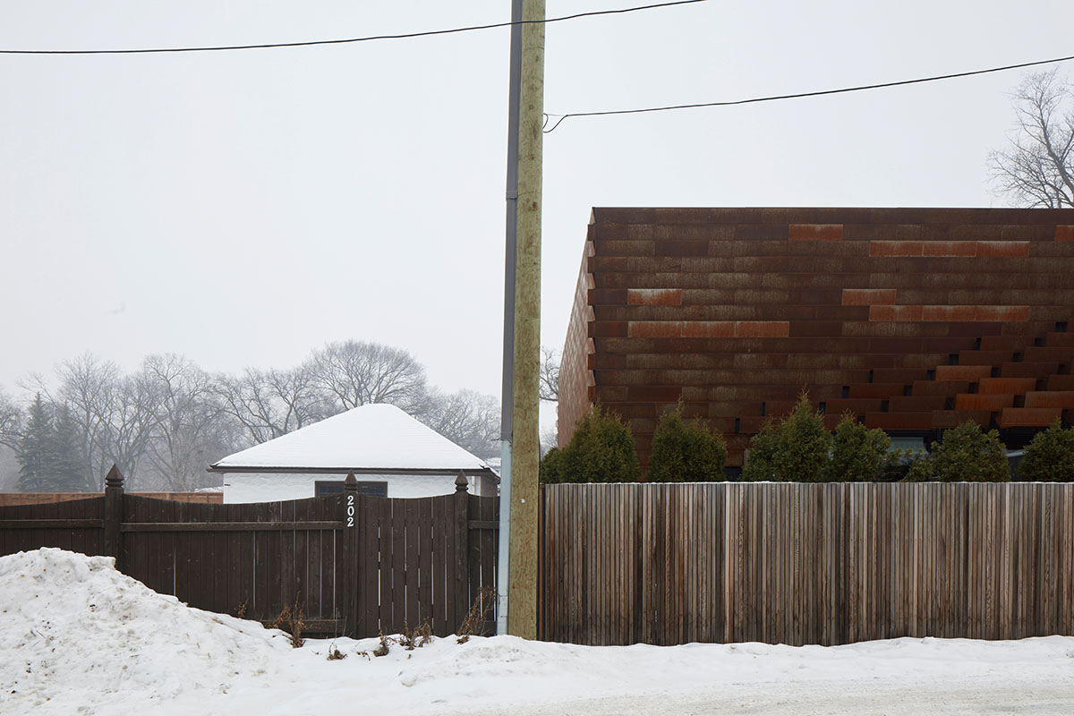 Weathered steel weil wraps the façade of Veil House in to resist snowfalls in Winnipeg