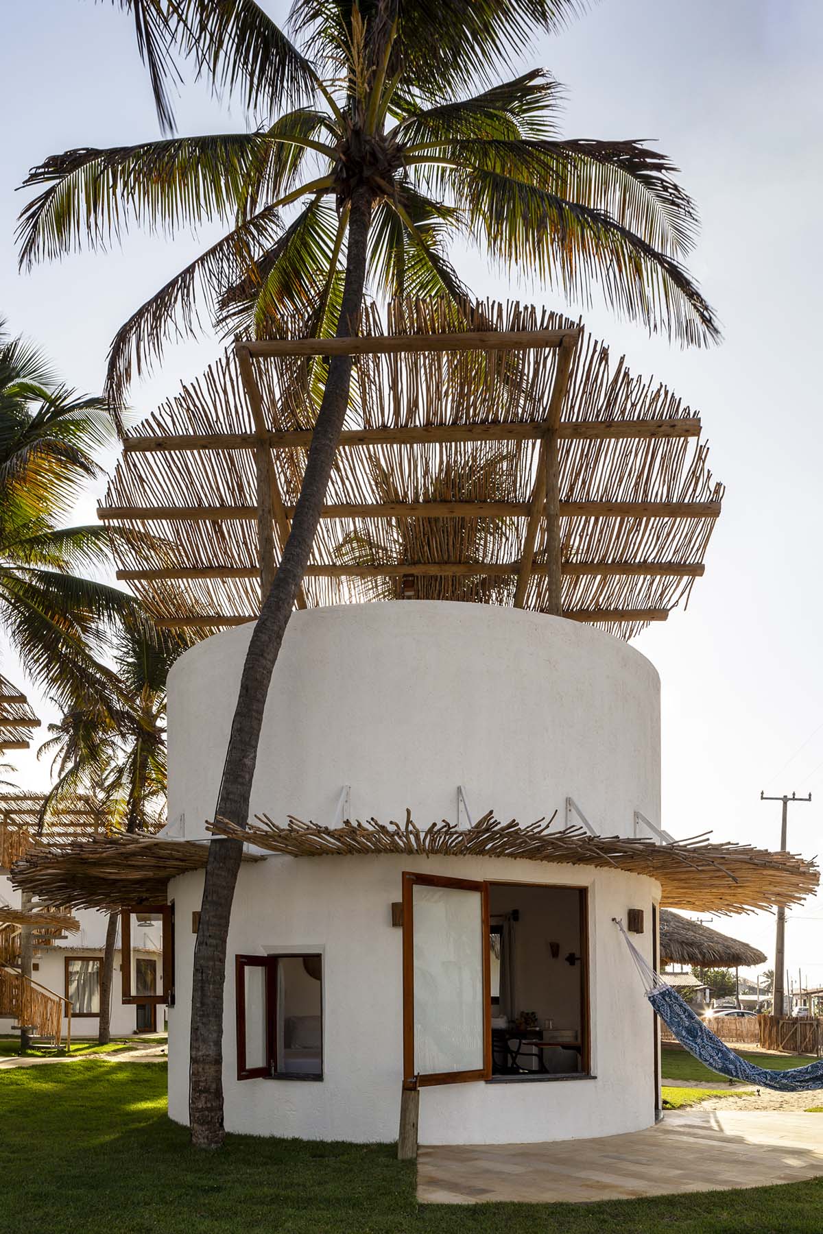 Lins Arquitetos Associados built village comprised of circular chalets overlooking coconut groves 