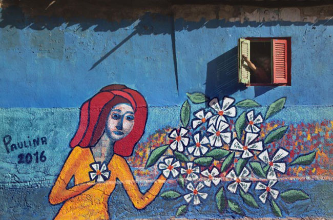 Mona Hassan captures Egyptian Village Festival Houses composed of colourful paintings by 40 artists