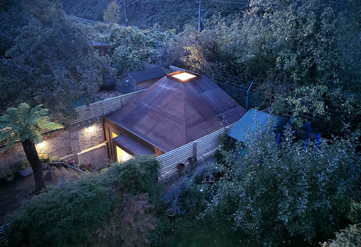 RISE Design Studio built sunken garden studio with rusted steel to provide a hidden place to escape