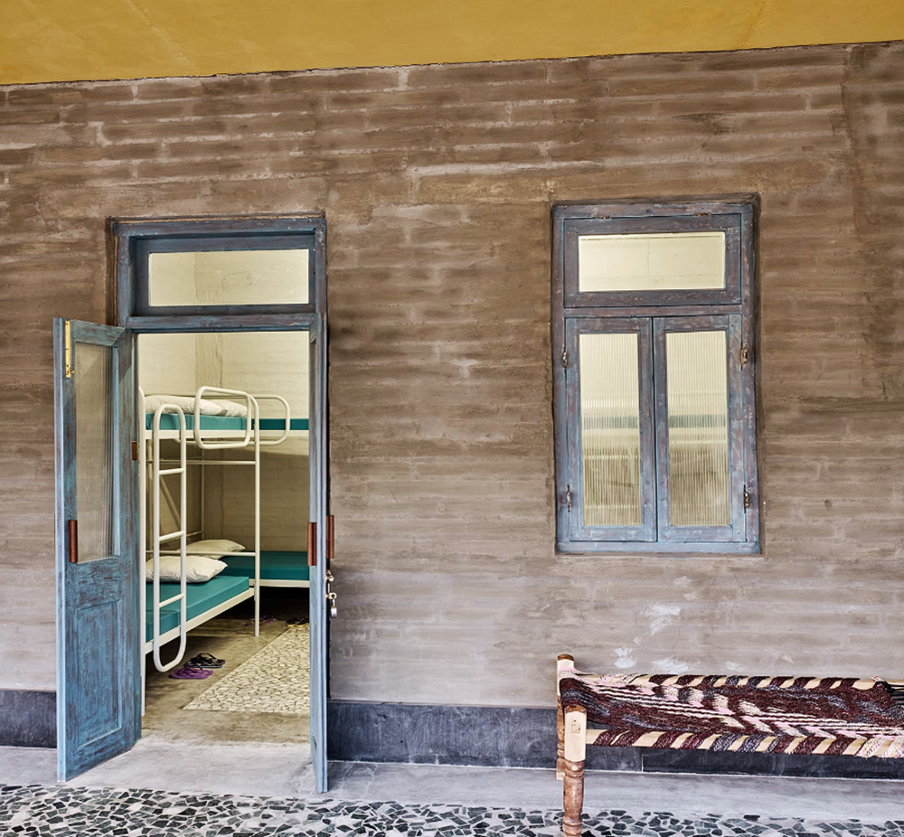 Avasara Academy, resembling an unfinished structure, educates young women in the moorland of Pune