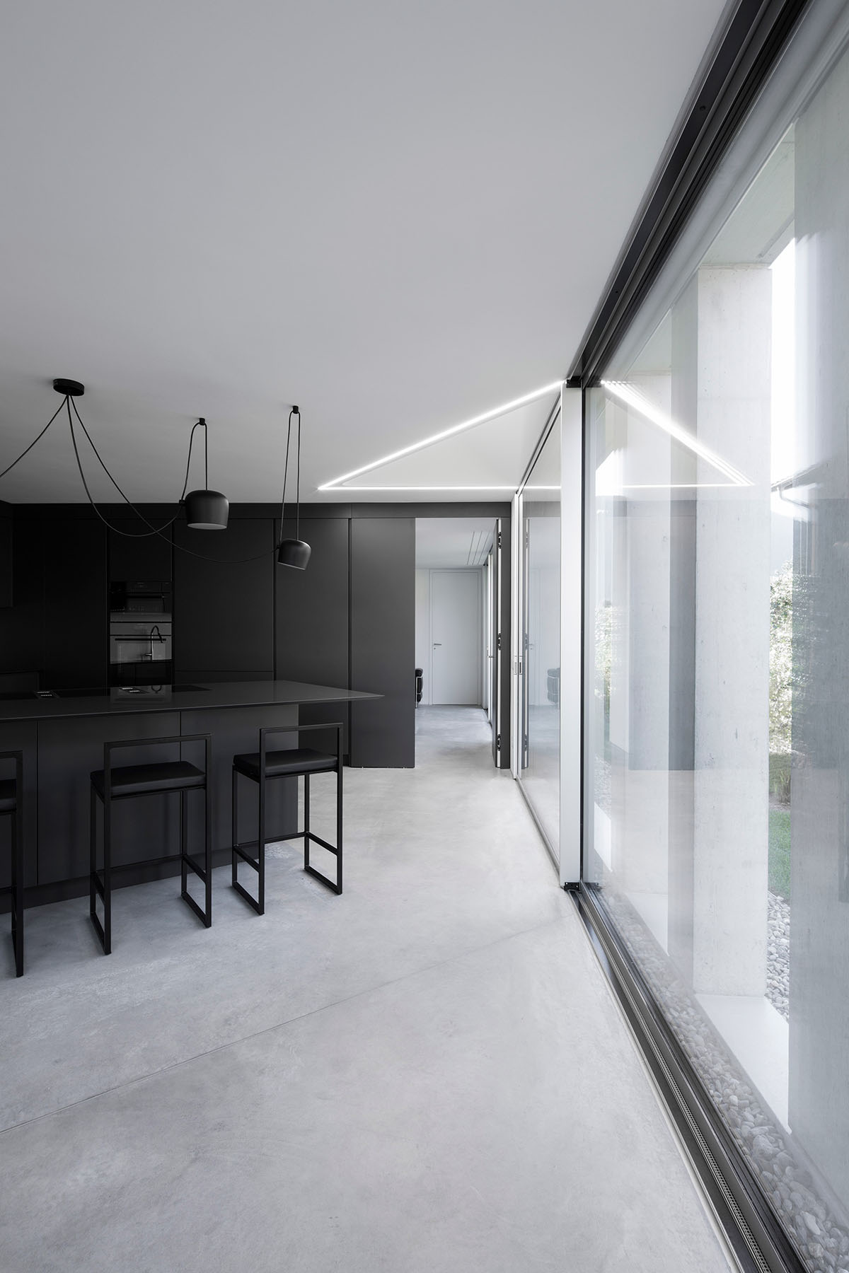 Grey concrete villa by DF_DC is characterised with trapezoidal colonnaded terrace on Comano hills