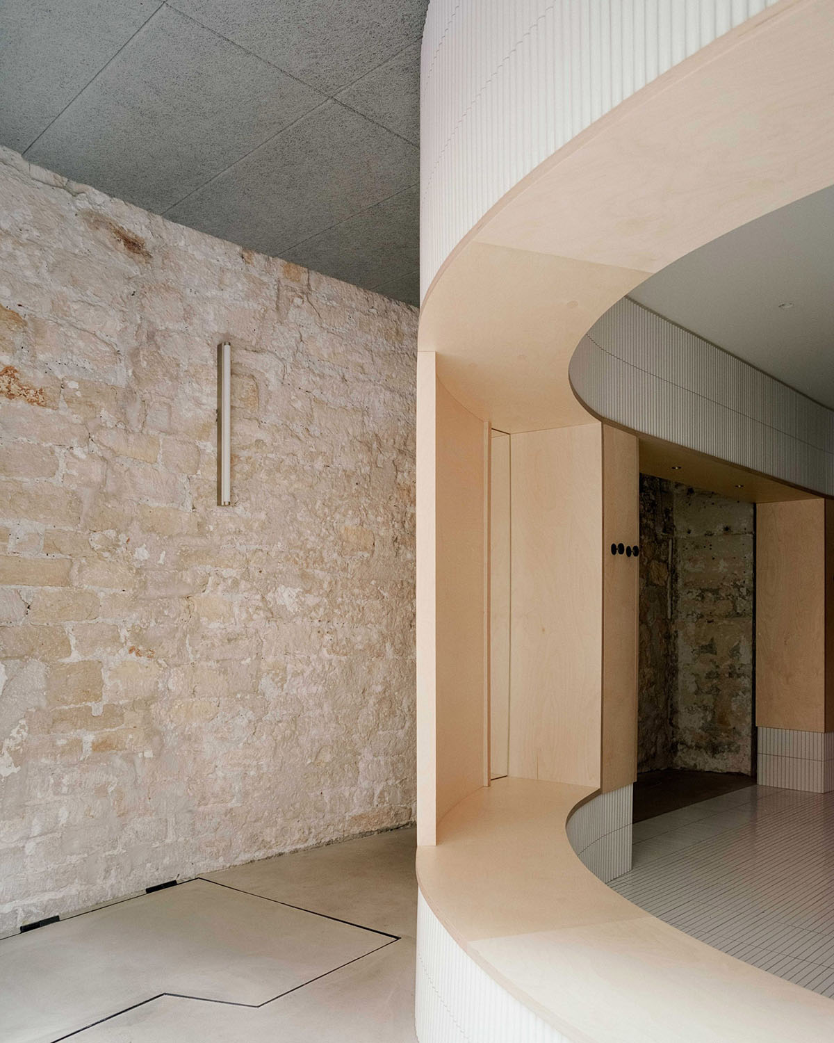 Neri&Hu-designed restaurant in Paris exposes layering material history with oblong volume inside