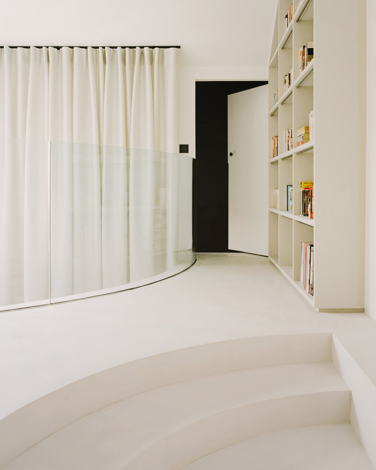 White concrete curved bridge gently complements interiors of The Island House in Paris