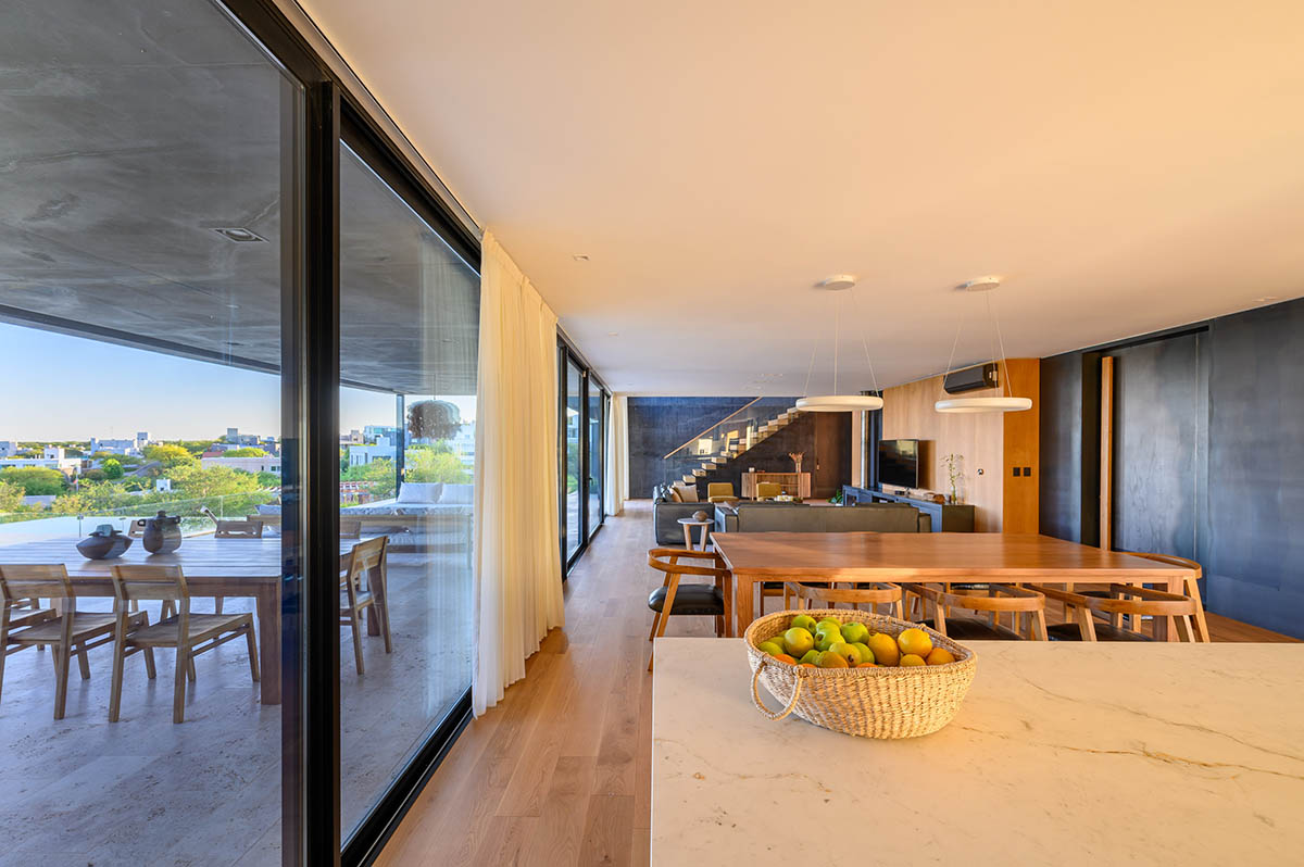 AR Arquitectos completes family home with black concrete and wooden cladding in Argentina 