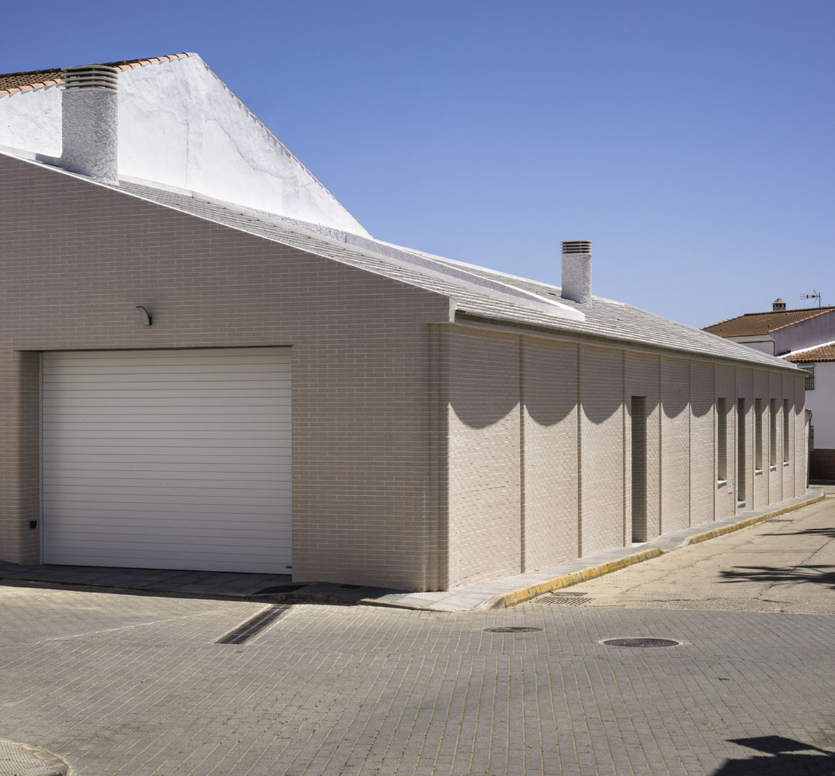 Studio Wet creates single linear space for a fortress-like family house in small village of Spain