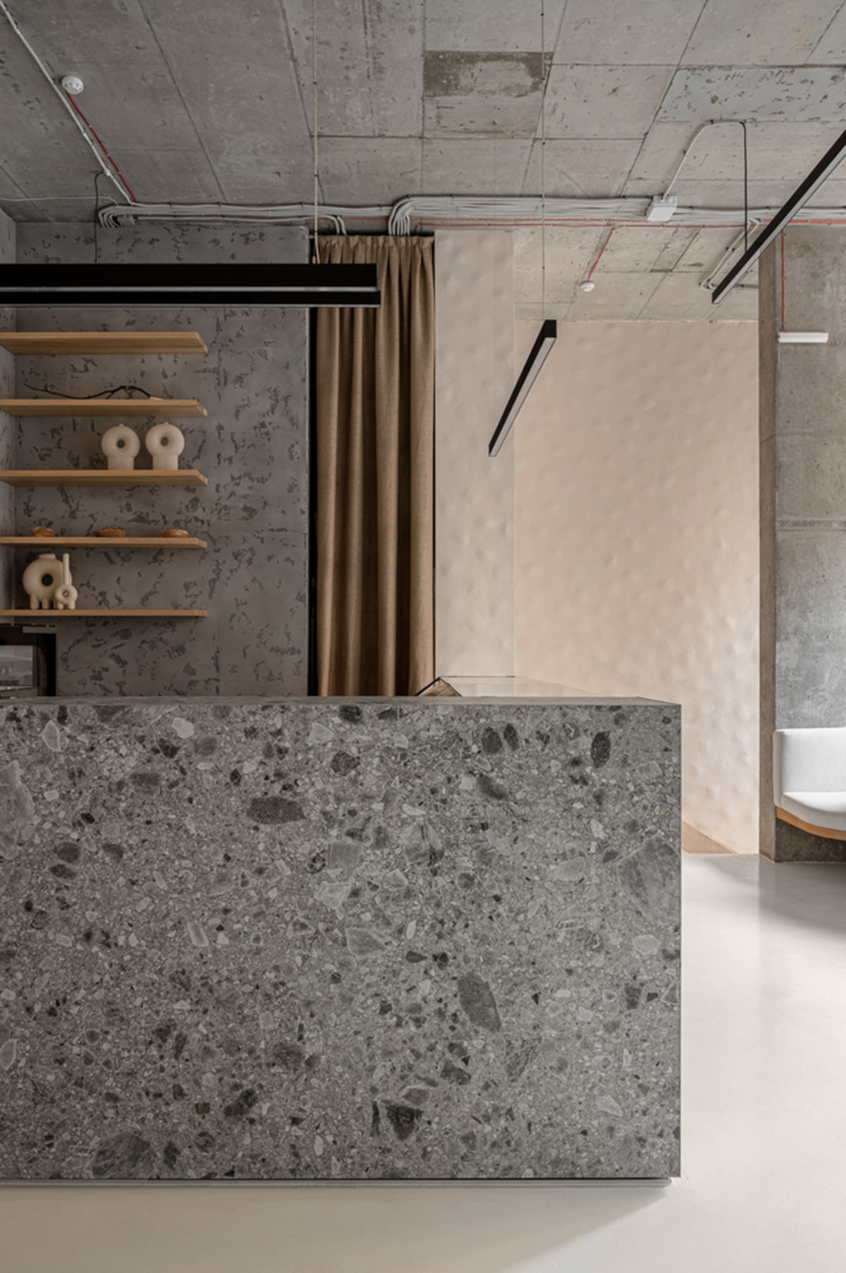 Earth-toned materials and soft lines form interiors of this ready-to-eat food restaurant in Kyiv