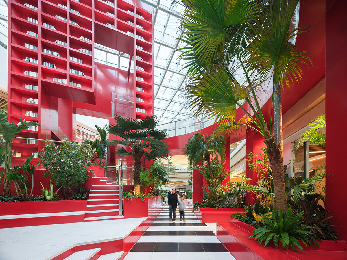 CLOU architects adds bright reddish cube to atrium to evoke Henri Rousseau’s mysterious paintings 