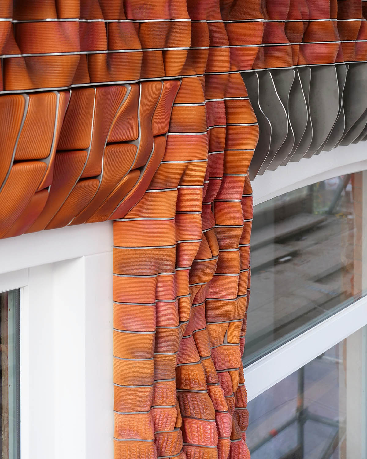 Studio RAP creates façade featuring bespoke 3D-printed ceramic tiles and bricks
