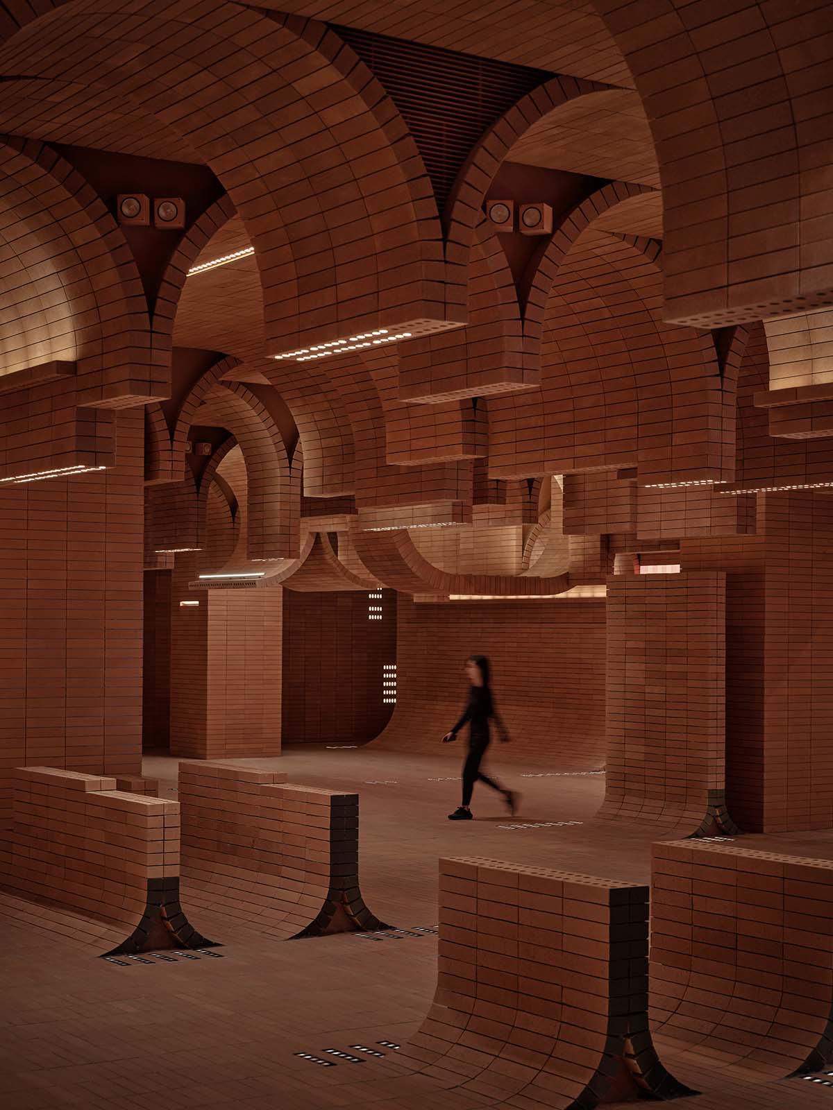 One Plus Partnership adds layered bricks to a cinema interior to resemble waves in Haikou
