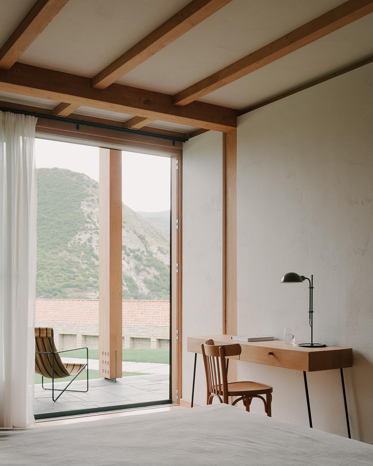 The stone and wood Tbilisi residence integrates architecture with the natural landscape