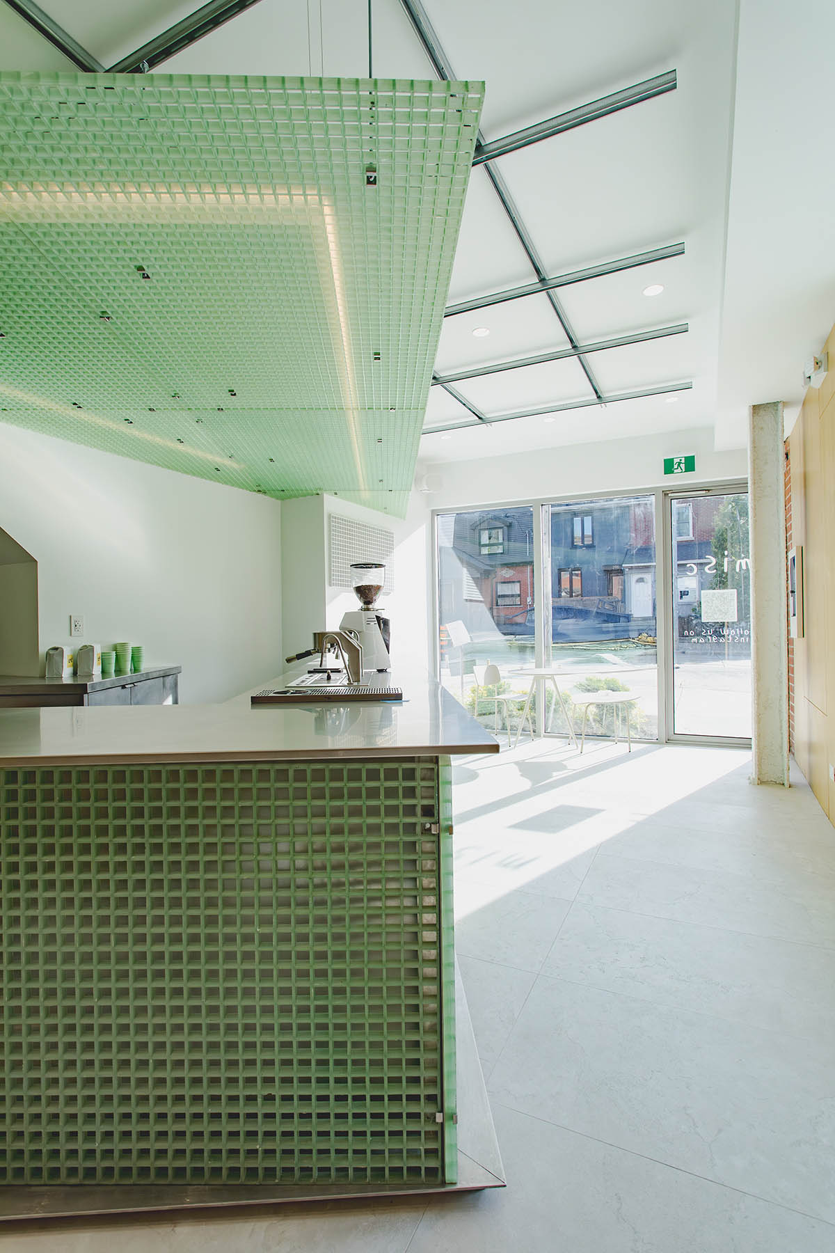 Misc Coffee makes a bold statement with green translucent bar in a busy street of Toronto