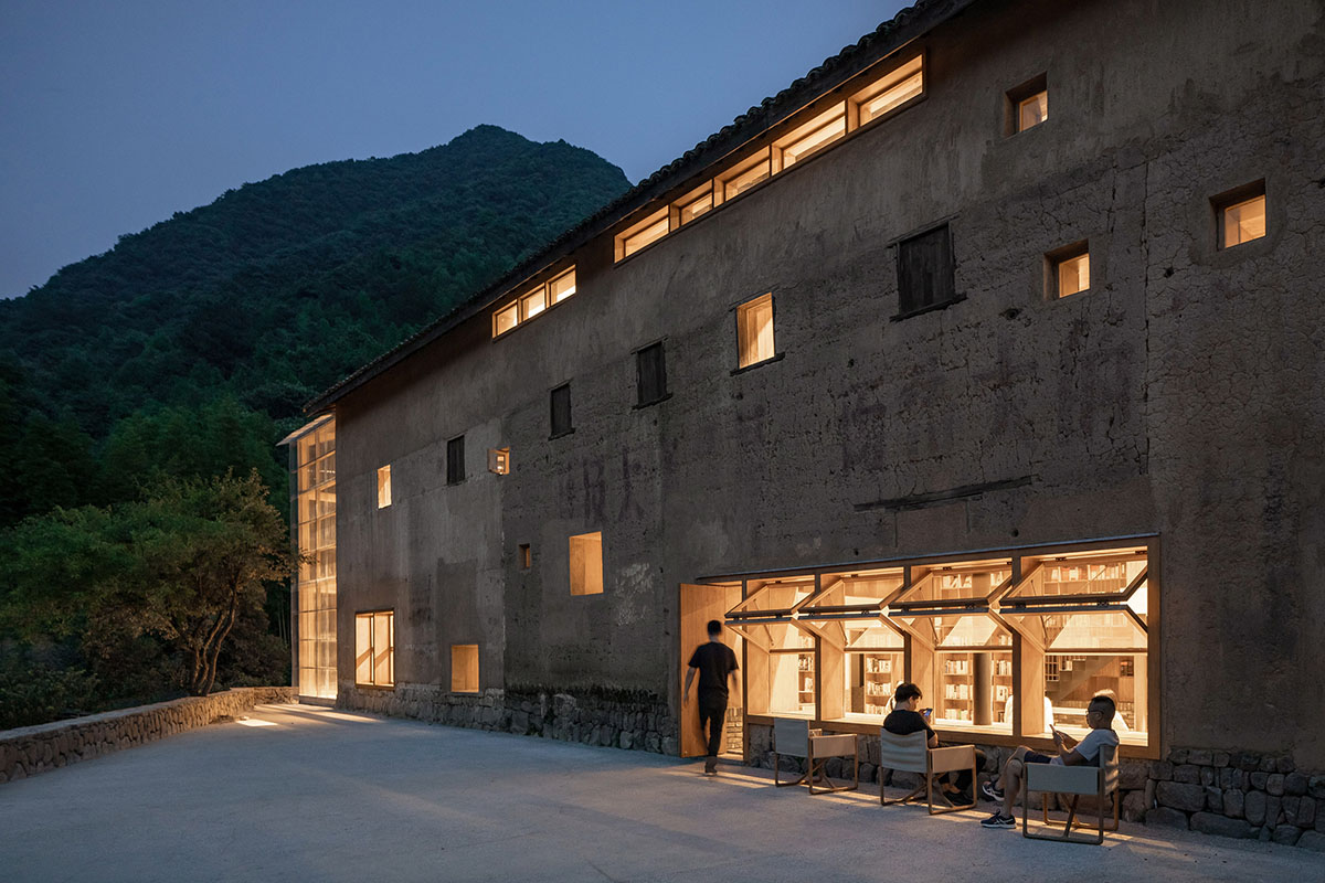 Atelier tao+c converts old building into capsule hotel with corrugated polycarbonate panels in China