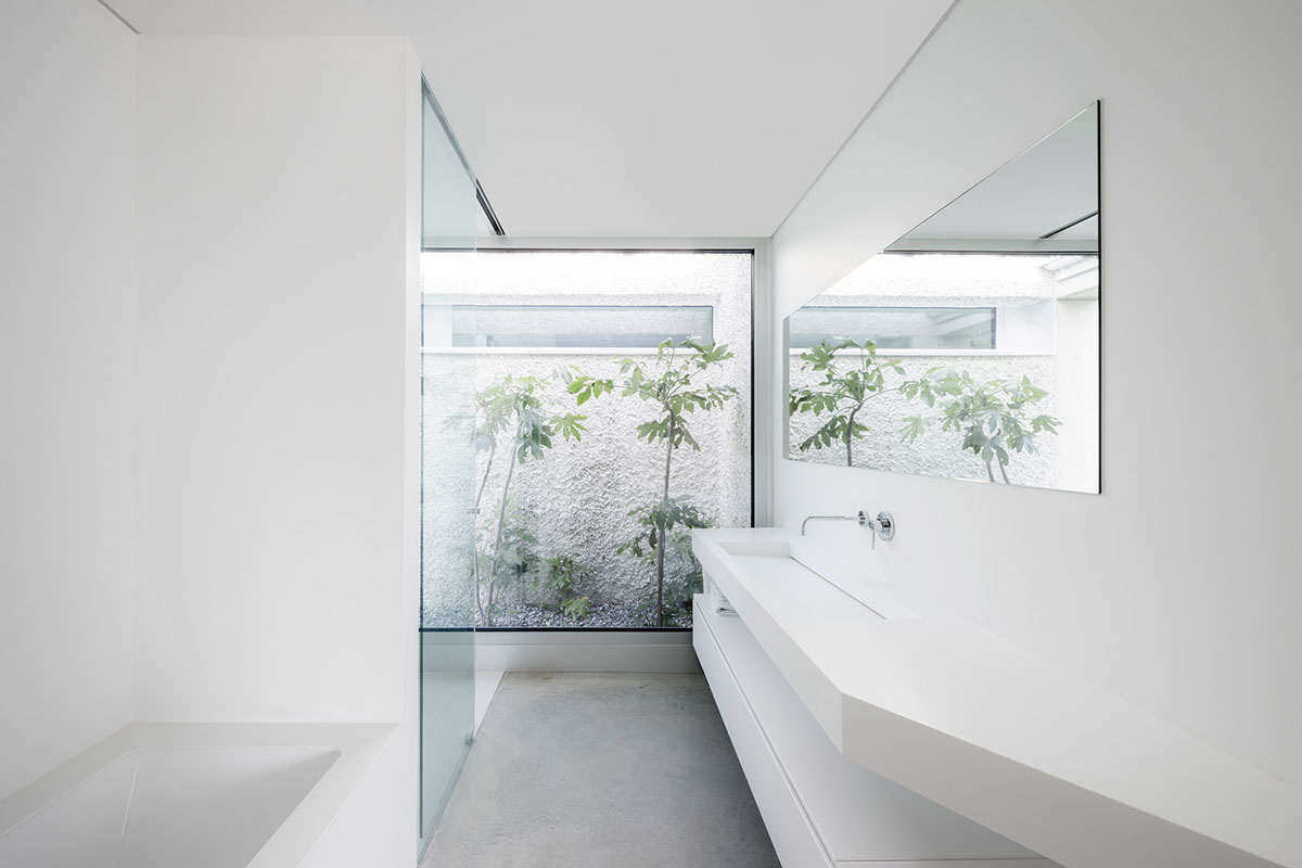 Grey concrete villa by DF_DC is characterised with trapezoidal colonnaded terrace on Comano hills