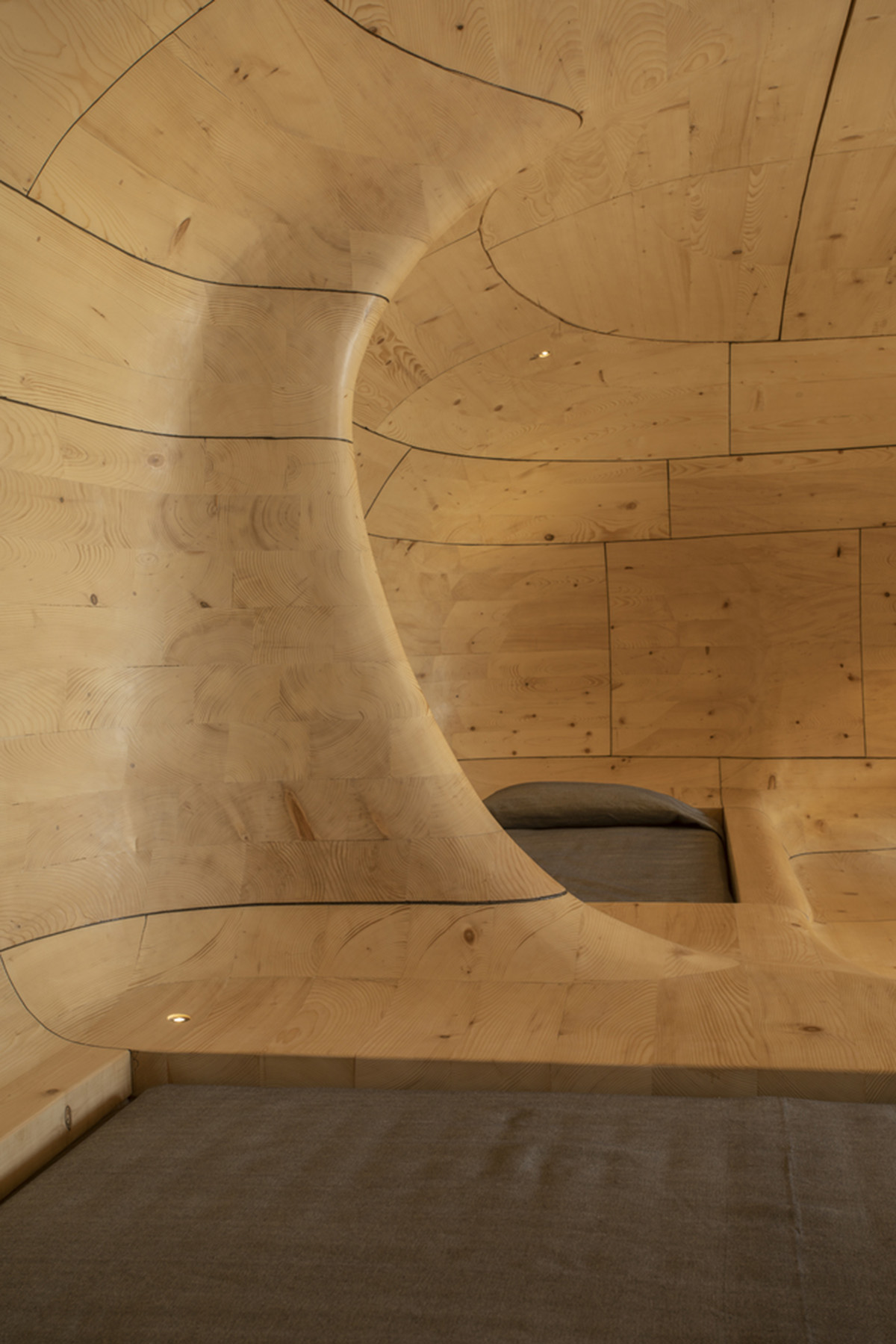 Tenon Architecture creates cave-like wooden interior for a resort in Greece