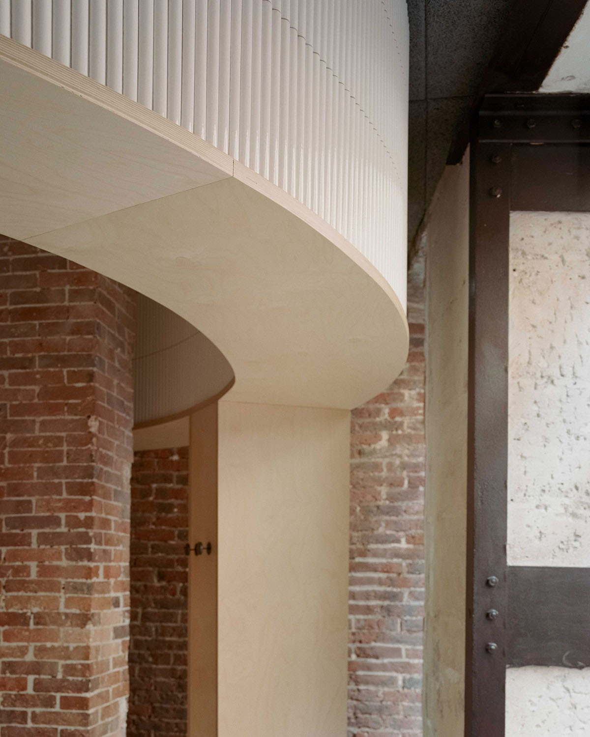 Neri&Hu-designed restaurant in Paris exposes layering material history with oblong volume inside