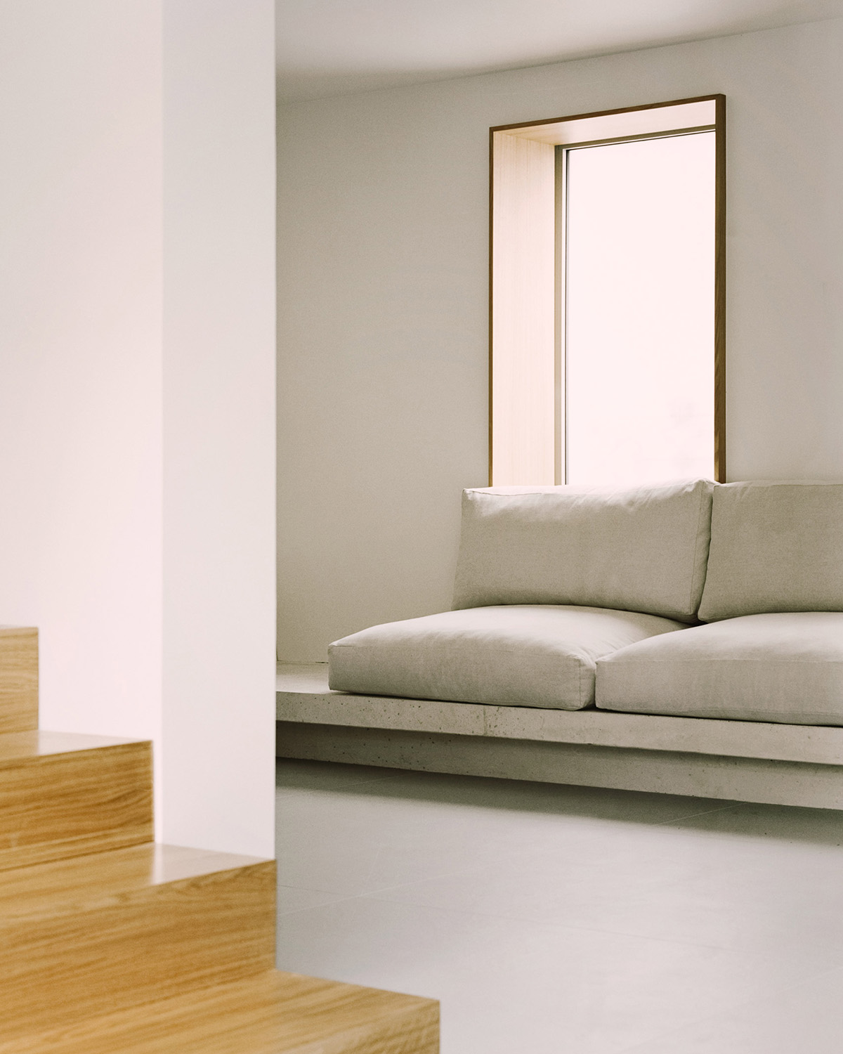 White concrete curved bridge gently complements interiors of The Island House in Paris