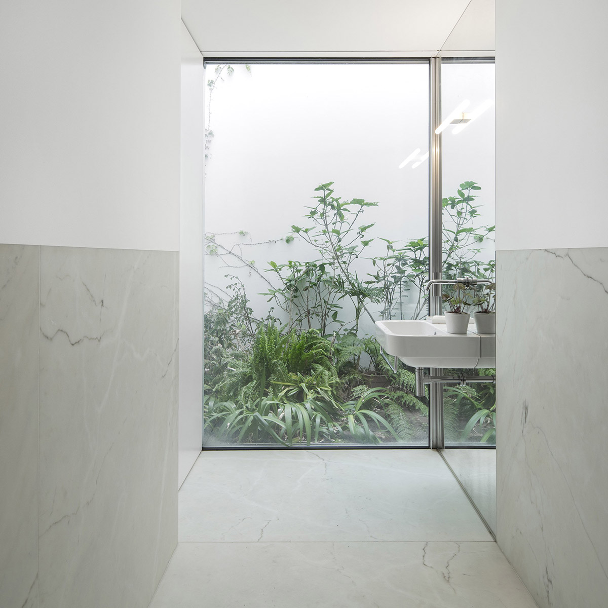 Extrastudio converted former winery in Portugal  into a new family home with red mortar walls