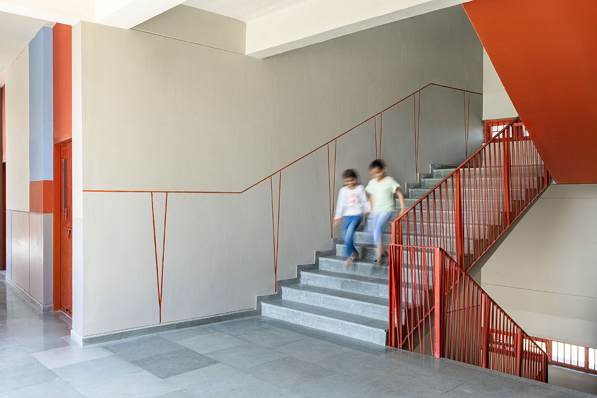 Kamat & Rozario Architecture built school with fortress-like blank walls and colored bridges