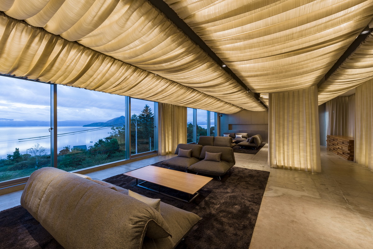 Kengo Kuma completes We Hotel Toya with cave-like interior on the shore of Lake Toya in Japan