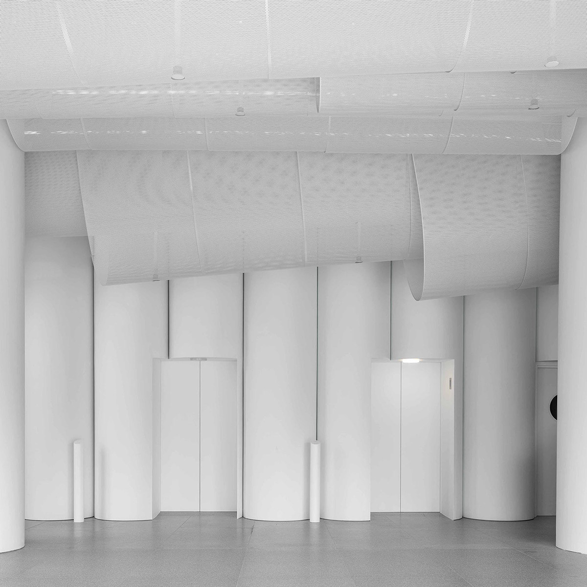 Atelier Nuno Architects suspends tubular aluminum panels from the ceiling of a lobby in Hong Kong