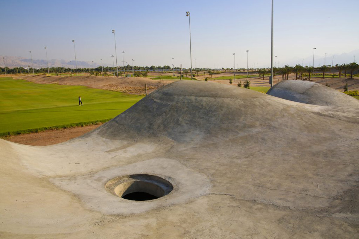 Oppenheim Architecture completes Ayla Golf Academy with wavy roofs in deserted landscape of Jordan
