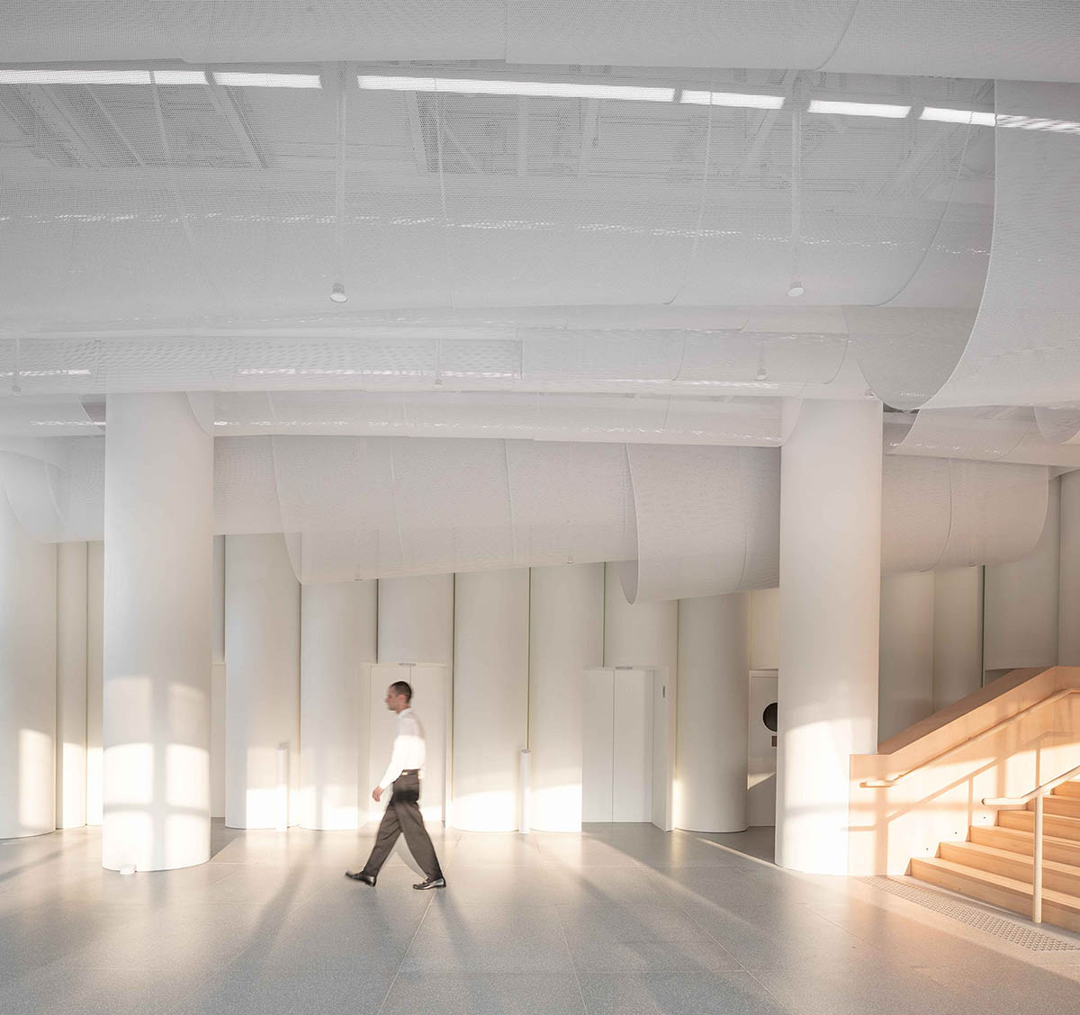 Atelier Nuno Architects suspends tubular aluminum panels from the ceiling of a lobby in Hong Kong