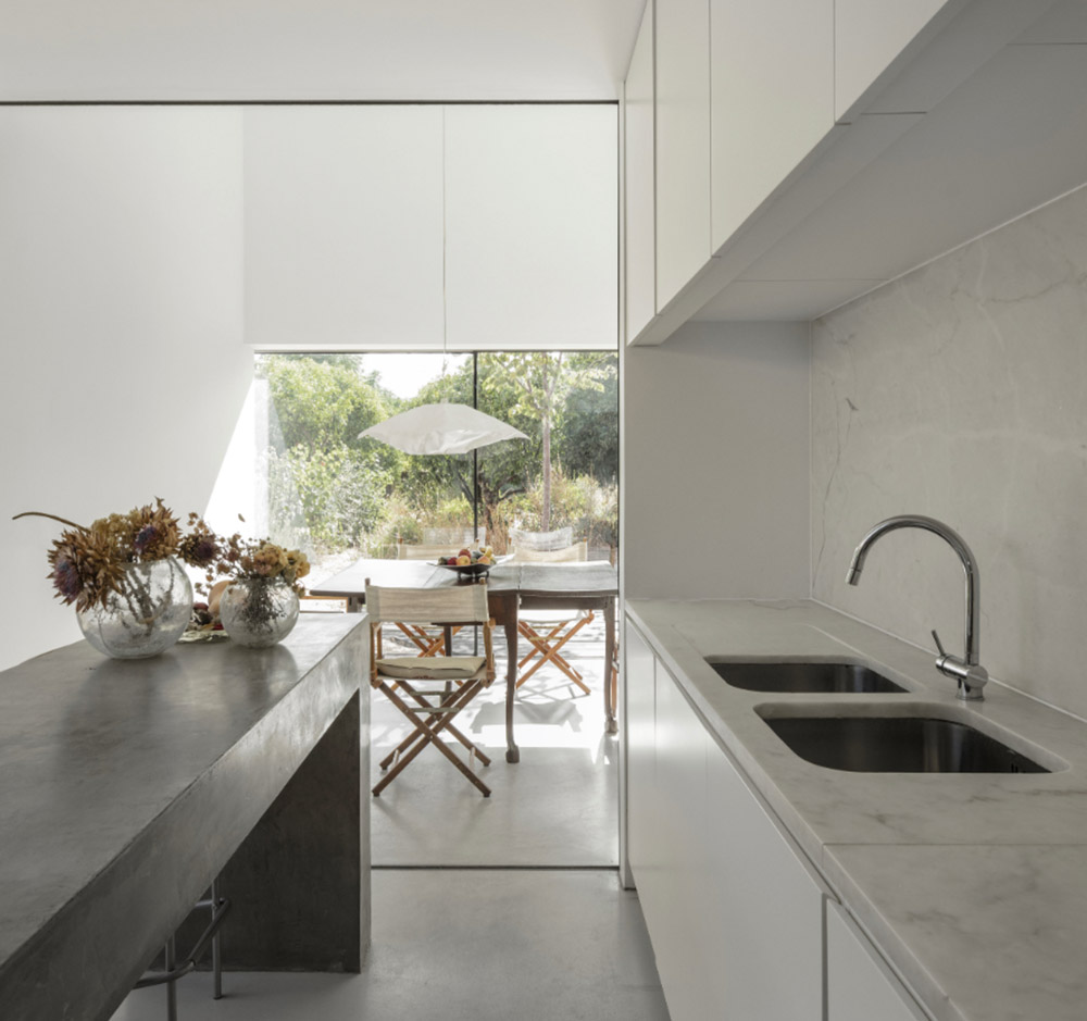 Extrastudio converted former winery in Portugal  into a new family home with red mortar walls