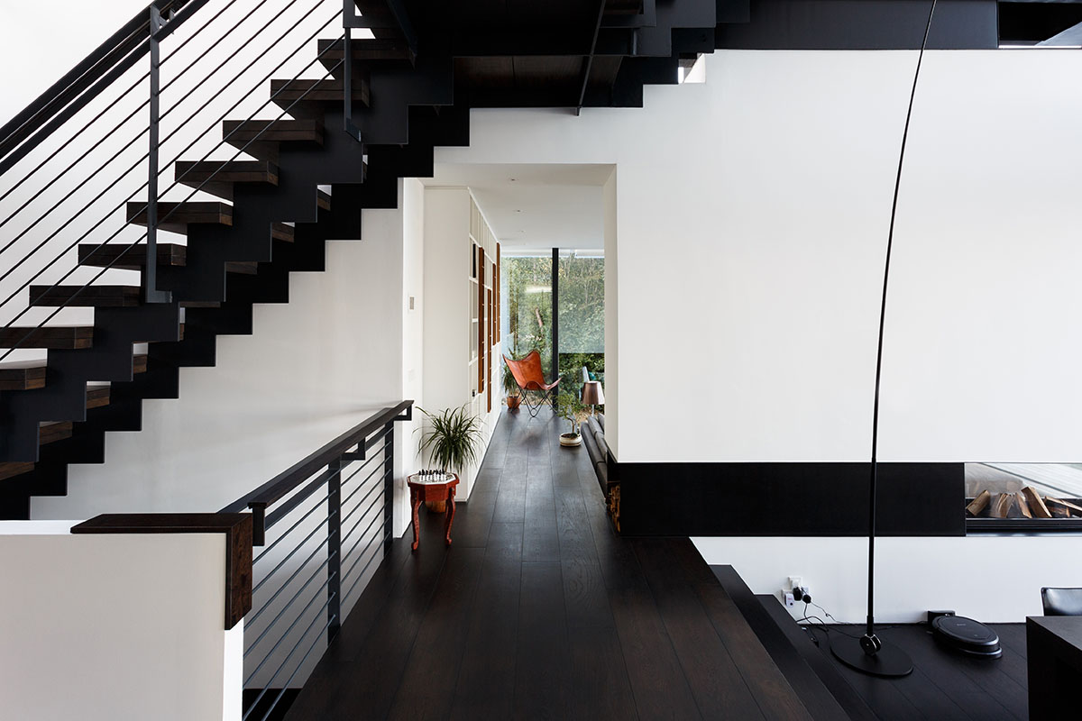 Mecanoo completes glass villa with dark stripes on a lake in Lechlade