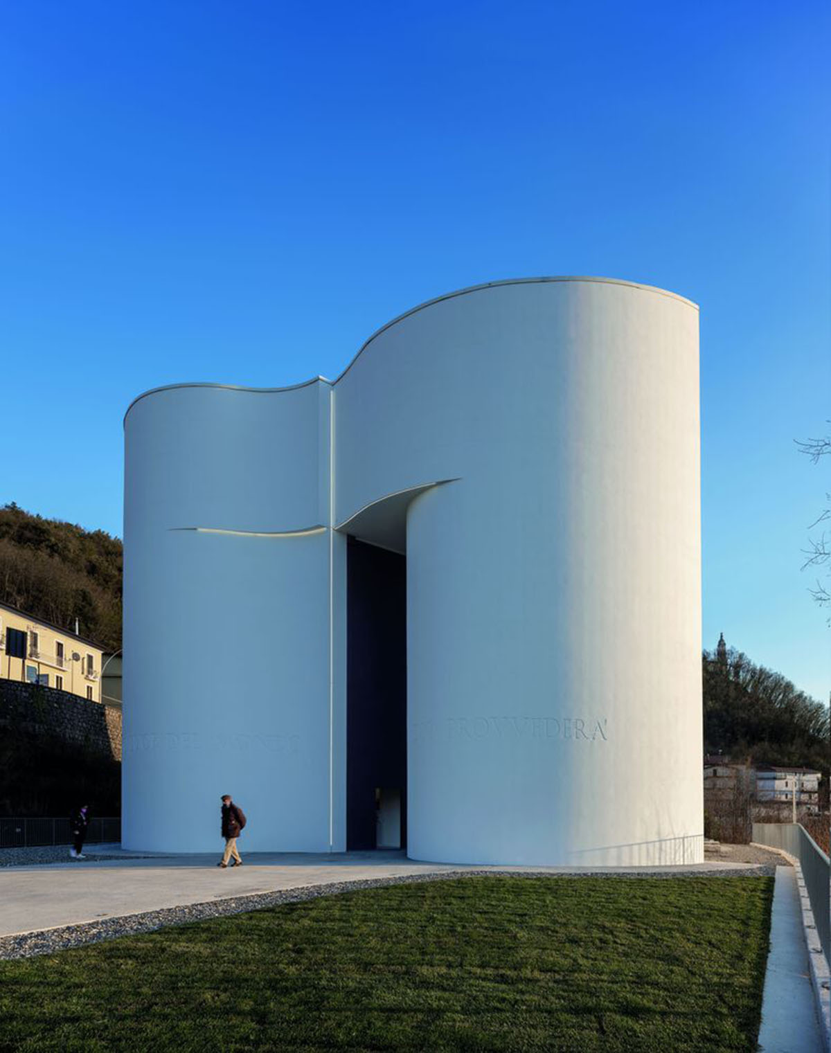 Smooth all-white walls form church designed by Mario Cucinella Architects in Mormanno hill town 