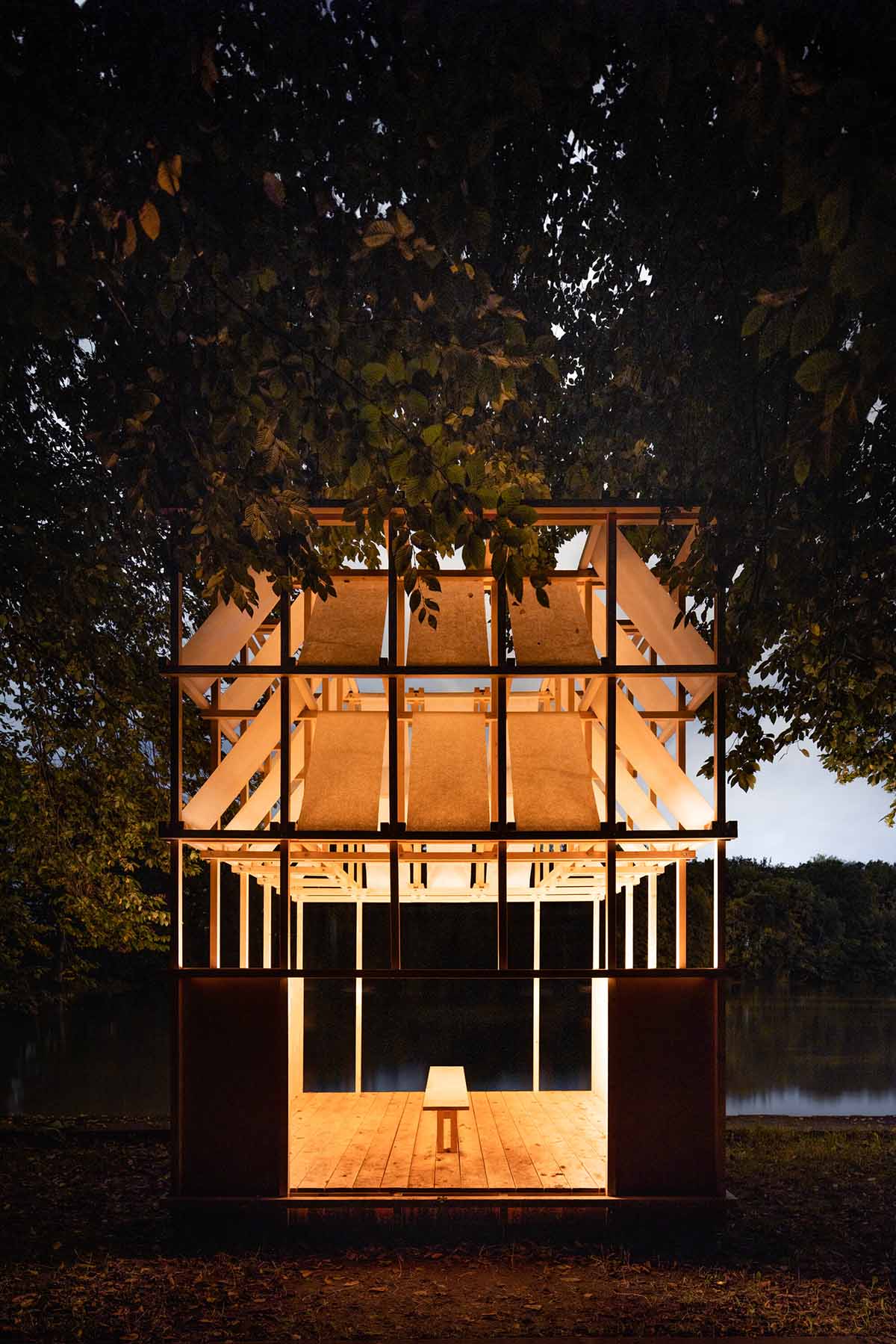 GRAU Architects built a tea house pavilion giving a ceremonial impression overlooking a lake 