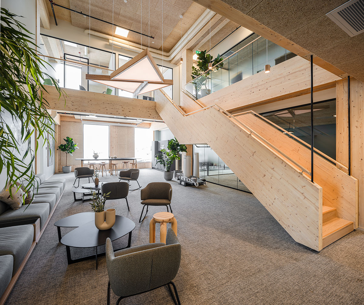 Oslotre Architects completes all-timber office building with curved wooden façade in Norway
