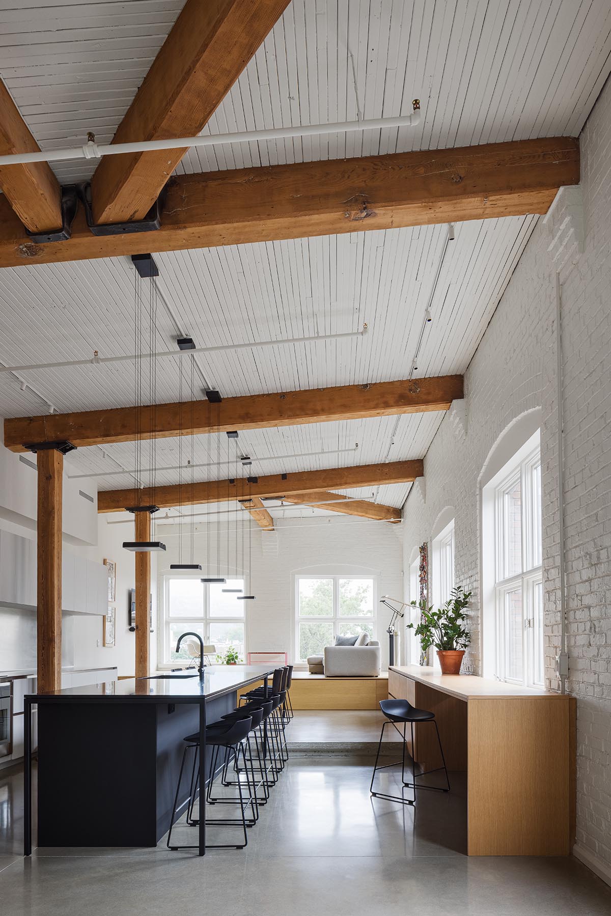 La Firme renovates historic mid-19th-century building with brick walls and oak cabinets in Montreal 