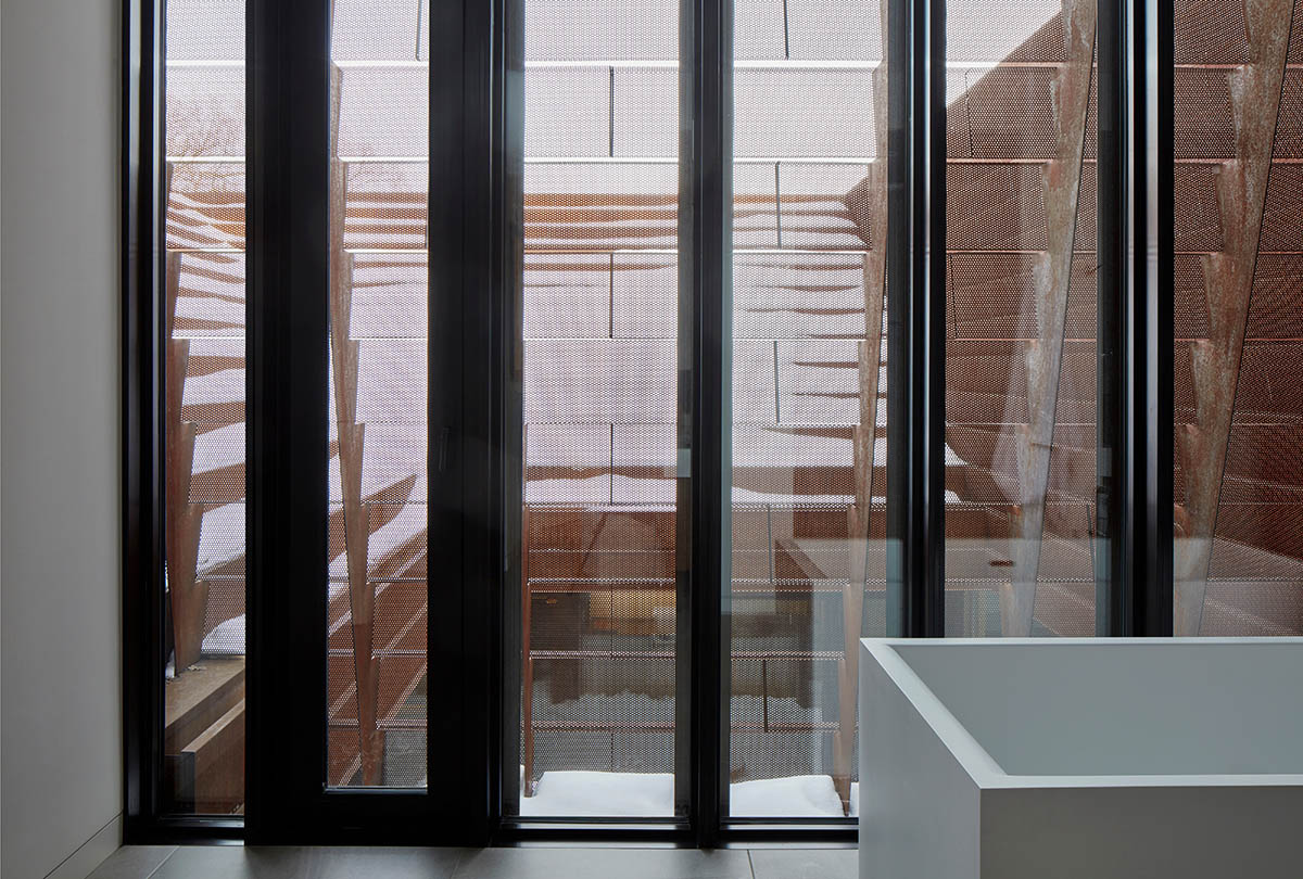 Weathered steel weil wraps the façade of Veil House in to resist snowfalls in Winnipeg