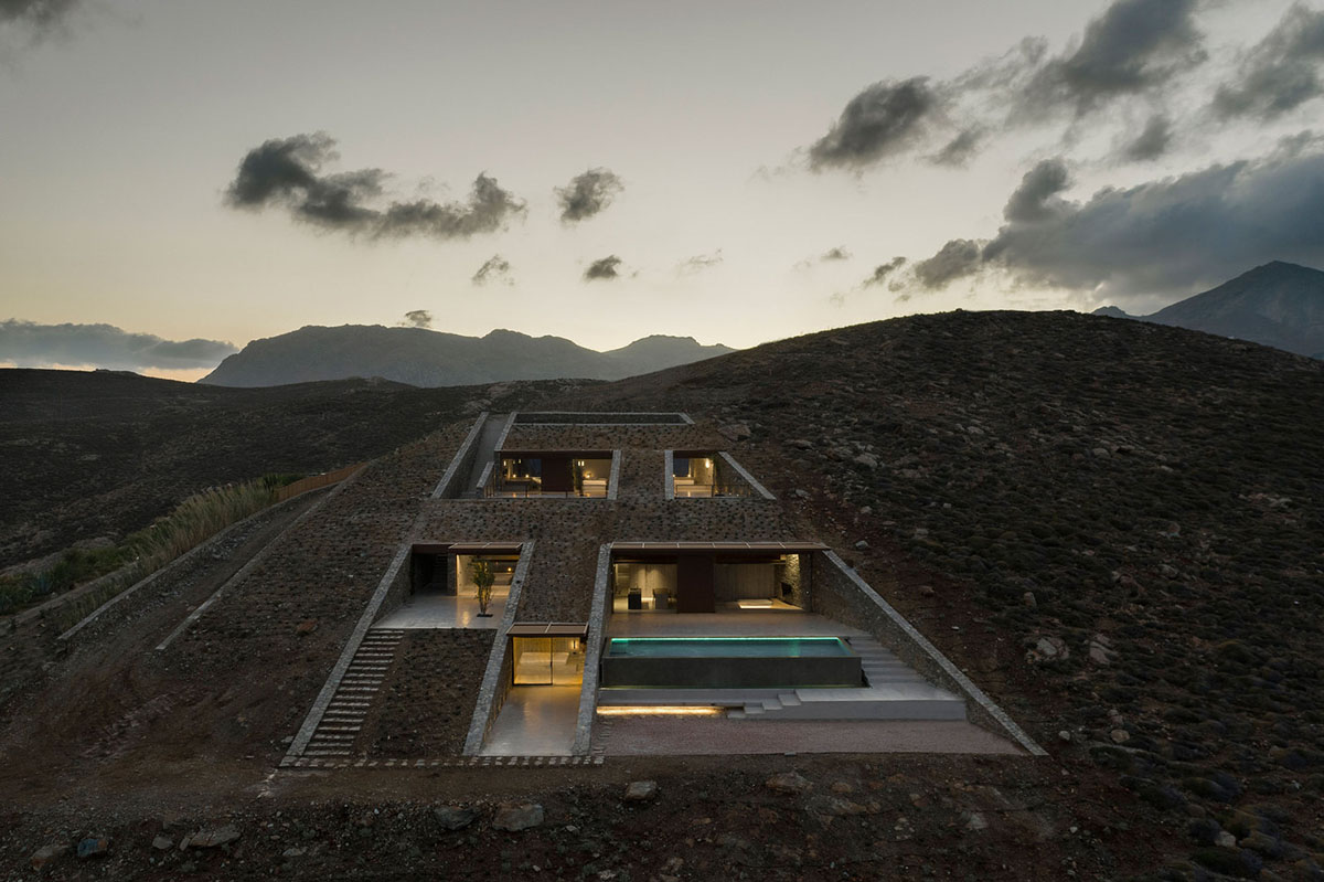 MOLD Architects used advantages of sloping land to design Ncaved house in Greece