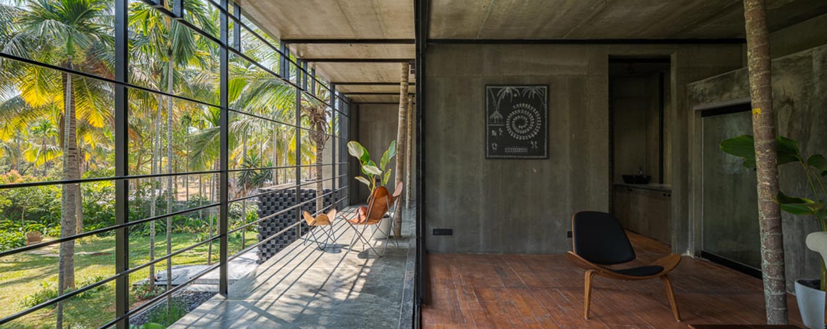 Parallax designs black weekend house raised on slender stilts within coconut trees in Bangalore
