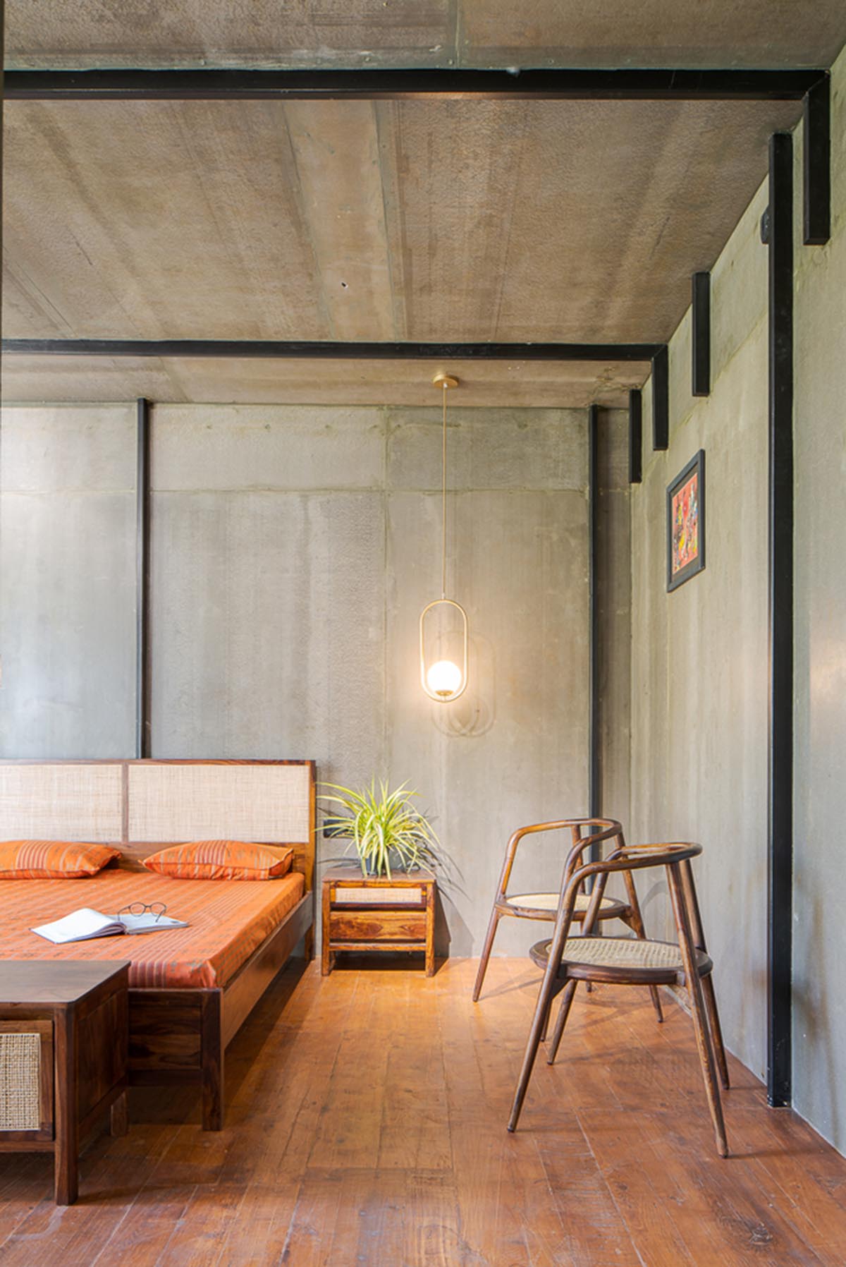 Parallax designs black weekend house raised on slender stilts within coconut trees in Bangalore